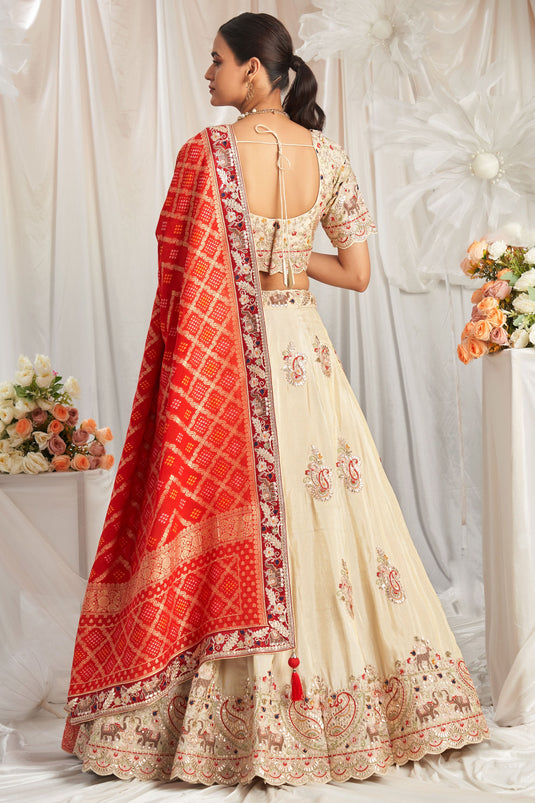 Flawless Tissue Thread Embroidery Cream And Red Lehenga Choli