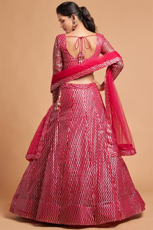 Coveted Embroidered Work On Rani Color Net Fabric Lehenga In Sangeet Wear