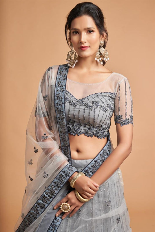 Grey Color Net Fabric Sangeet Wear Precious Lehenga With Embroidered Work