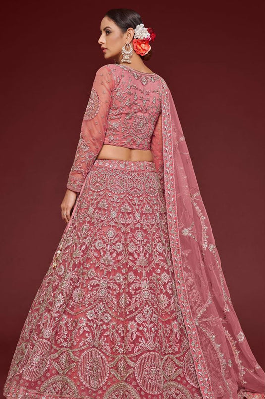 Tempting Net Fabric Peach Color Lehenga With Embroidered Work