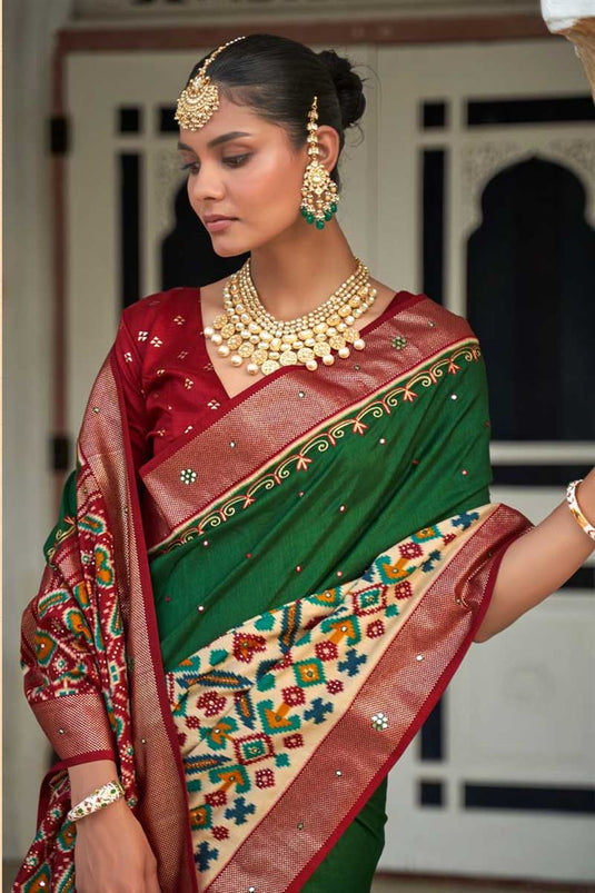 Appealing Patola Printed Art Silk Fabric Saree In Dark Green Color