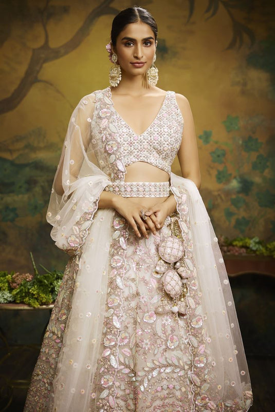 Tempting Net Fabric Cream Color Wedding Wear Lehenga Choli With Embroidered Work