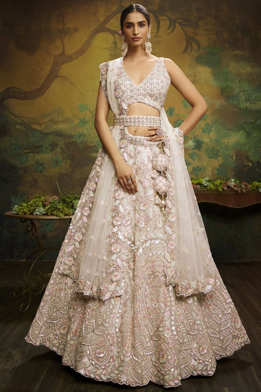 Tempting Net Fabric Cream Color Wedding Wear Lehenga Choli With Embroidered Work